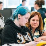 An advisor helps a student complete paperwork