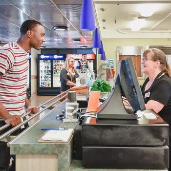 A student worker working behind the counter in the campus restaurant